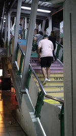 Rear view of woman walking in corridor