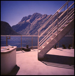 Bridge over lake against mountain range