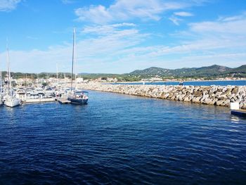 Boats moored in sea against sky