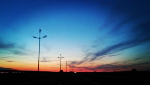 Street against sky at sunset