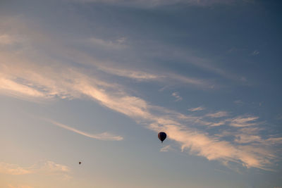 Low angle view of hot air balloons against sky during sunset