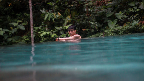 Surface level of young man in lake