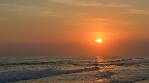 Scenic view of sea against romantic sky at sunset