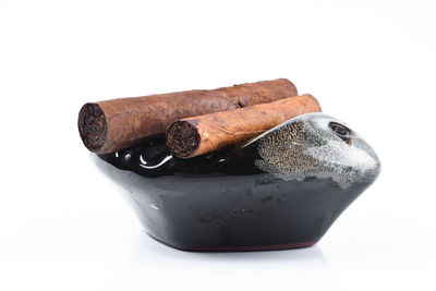 Close-up of ice cream on table against white background