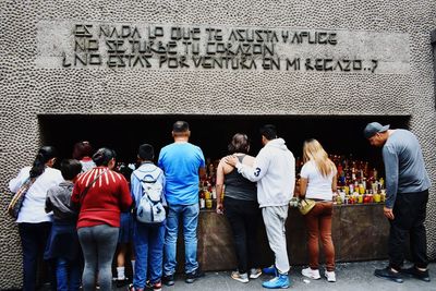 Group of people standing against wall