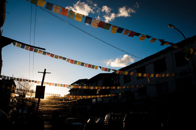 Low angle view of flags hanging against sky