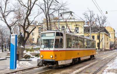 View of railroad tracks on street in city