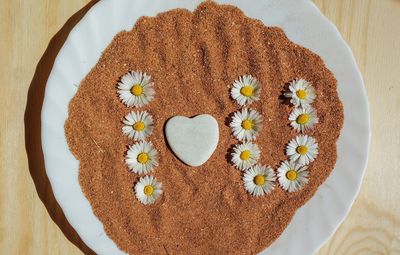 High angle view of heart shape on white table