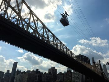 Low angle view of bridge against cloudy sky