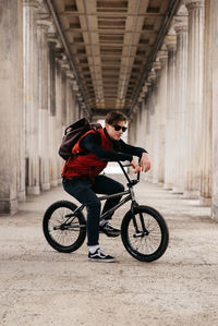 Man riding bicycle in corridor