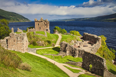 Built structure by sea against sky