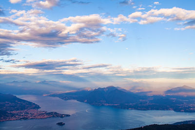 Scenic view of sea and snowcapped mountains against sky during sunset