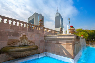 View of swimming pool by building against sky