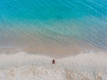 High angle view of woman standing at beach