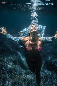 High angle view of woman swimming in sea