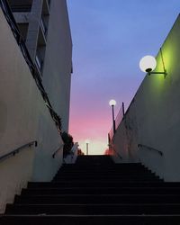 Low angle view of staircase by building against sky