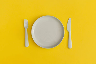 Directly above shot of yellow and spoon on table