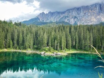 Scenic view of lake by mountains against sky