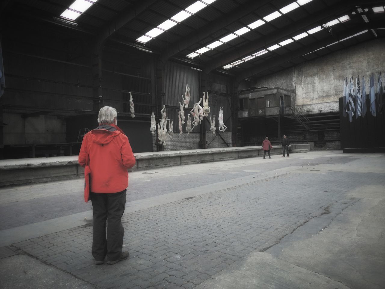 REAR VIEW OF PEOPLE WALKING ON SUBWAY STATION