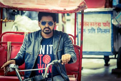 Portrait of young man riding jinriksha