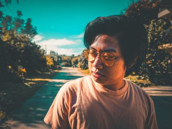 Young man standing on road