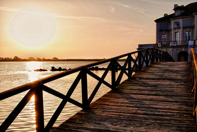 Bridge over river at sunset