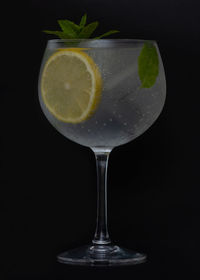 Close-up of beer glass against black background