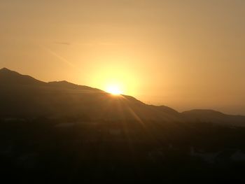 Scenic view of silhouette mountains against sky during sunset