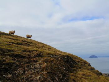 Scenic view of the mountain by sea against sky