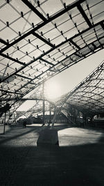 Low angle view of railroad station against sky