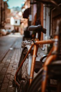 Close-up of bicycle parked on footpath