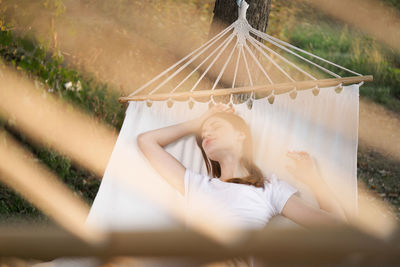 Woman lying down on hammock