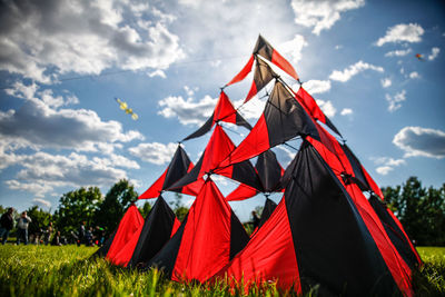 Kite on field against sky