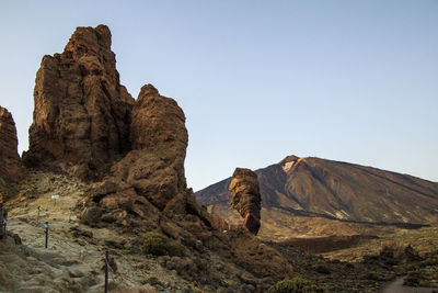 Rock formations on landscape against clear sky