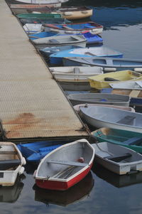 High angle view of rowboats moored on pier at harbor