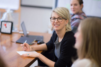 Portrait of young woman sitting outdoors