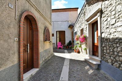 A narrow street among the old houses of greci, a village in the campania region, italy.