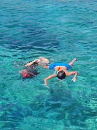 High angle view of people swimming in sea