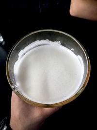 Close-up of hand holding beer glass