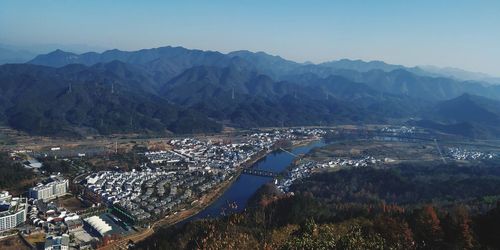 High angle view of buildings and mountains against sky