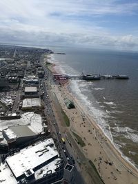 High angle view of cityscape by sea against sky