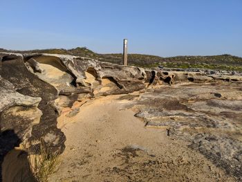 Scenic view of rocks against clear sky