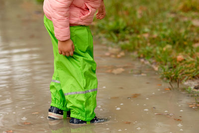 Low section of person standing on field