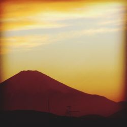 Scenic view of silhouette mountains against sky at sunset