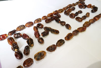 High angle view of coffee beans on white background