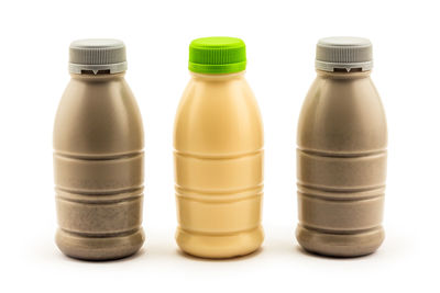 Close-up of bottles against white background