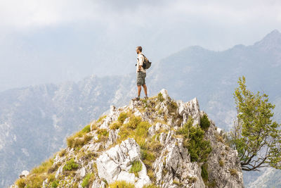 Italy, massa, man standing on top of a peak in the alpi apuane mountains