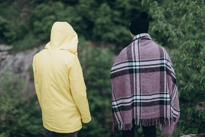 Rear view of couple kissing outdoors