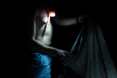 Close-up of person hand in darkroom