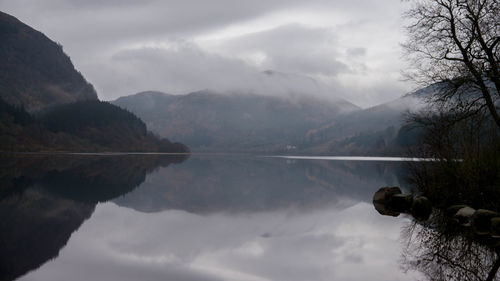 Scenic view of lake against cloudy sky